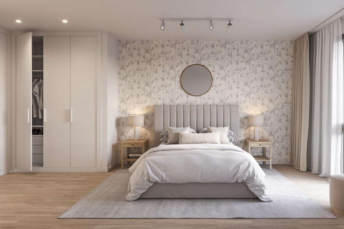 Modern bedroom in an Alicante apartment featuring a comfy bed, elegant decor, and ample storage space.