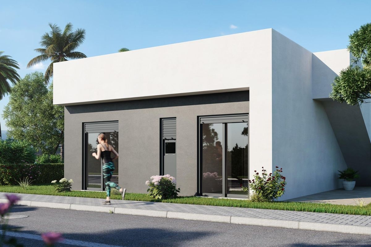 Zijaanzicht van een moderne 3-slaapkamer villa in Alhama De Murcia, met ontwerp en nabijgelegen groenvoorziening.