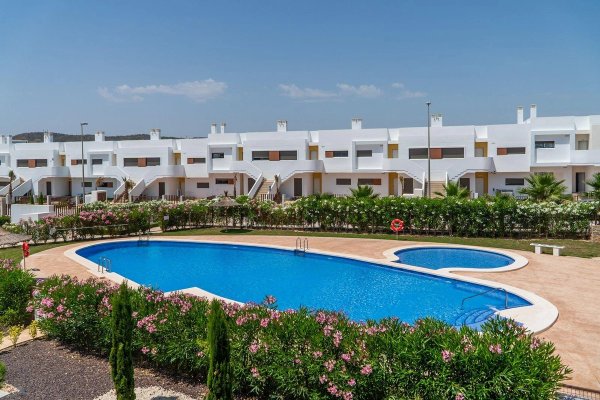 View of the communal pool surrounded by greenery at a 3-bed apartment in Orihuela, Costa Blanca South.