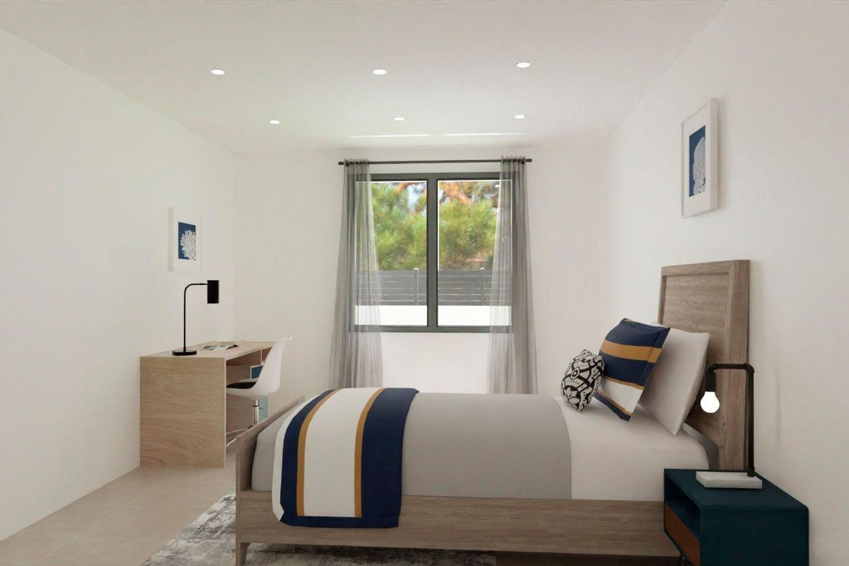 Warmly lit modern bedroom in the 3-bed villa featuring a work desk in Monforte del Cid, Costa Blanca.