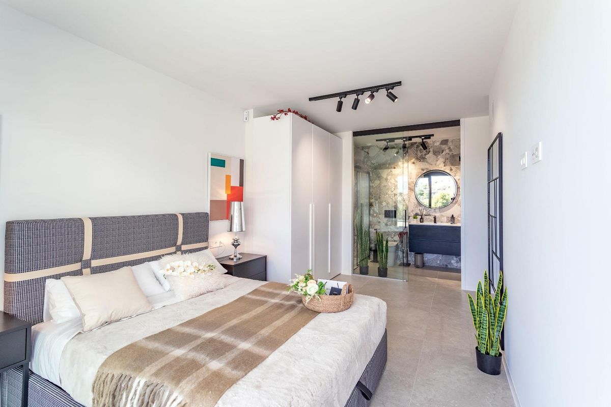 Gezellige slaapkamer met stijlvolle inrichting en ensuite badkamer in een 2-slaapkamerappartement in Finestrat, Costa Blanca.