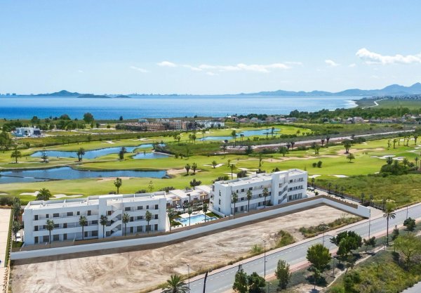Aerial view of a 2-bed apartment complex in Los Alcazares next to golf course and coastline.