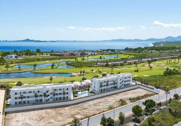Aerial view of a 2-bed apartment complex in Los Alcazares next to golf course and coastline.
