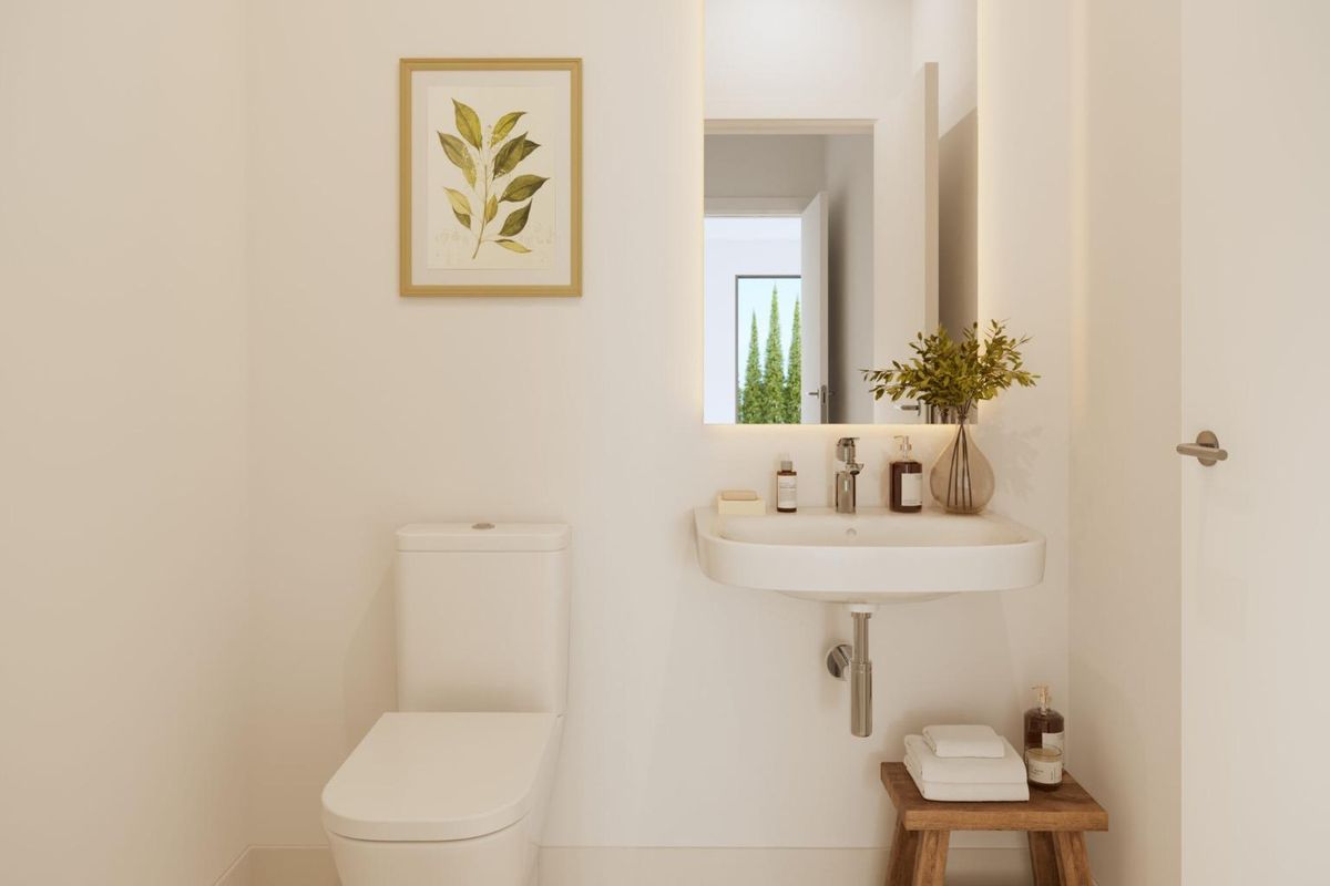 Compacte gastentoilet met planten decor in een stijlvol townhouse in Vélez Málaga, Costa del Sol.
