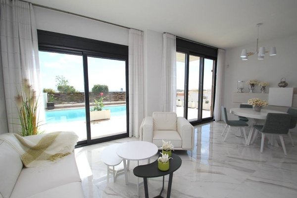 Stylish living area with views of the pool in a modern 2-bed villa in Orihuela Costa, Costa Blanca South.