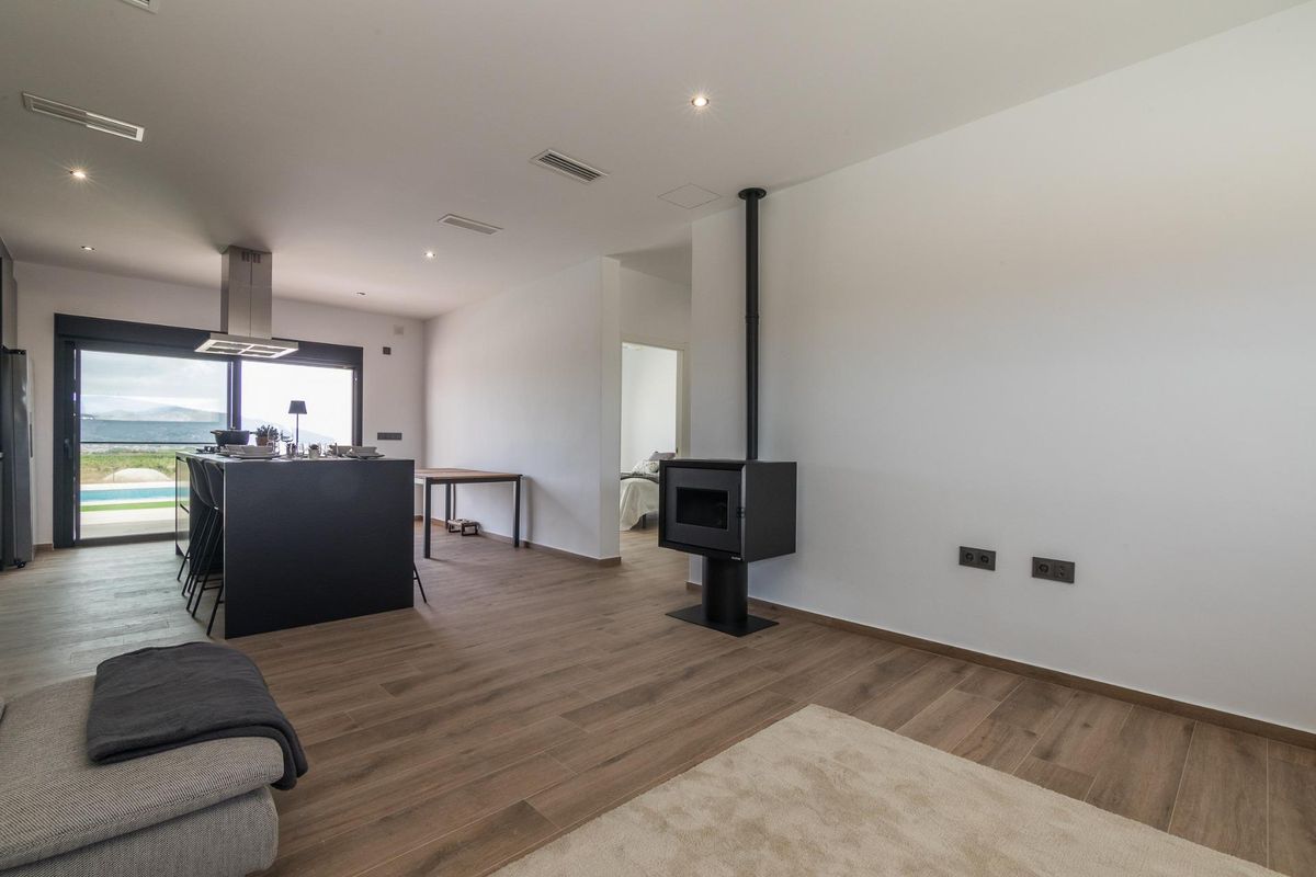 Open living space with views in a modern 3-bed villa in Pinoso, highlighting a stylish wood stove.