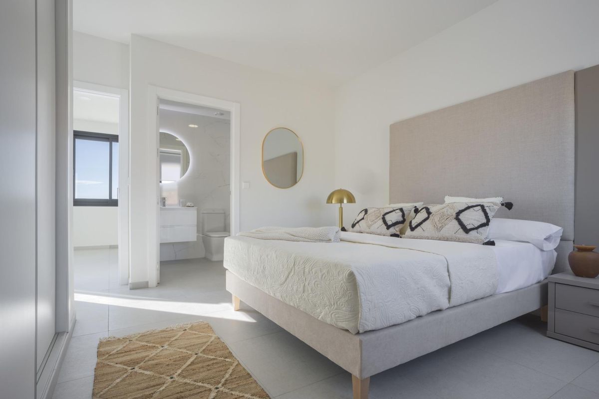 Stijlvolle slaapkamer met toegang tot de ensuite badkamer, inbouwkast en moderne meubels in Baños y Mendigo.