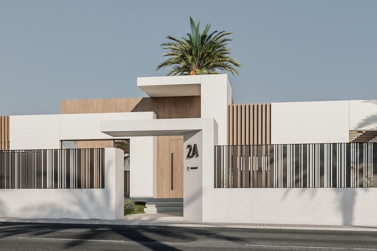 Stylish facade of a townhouse in El Campello, showcasing modern architecture and secure fencing.