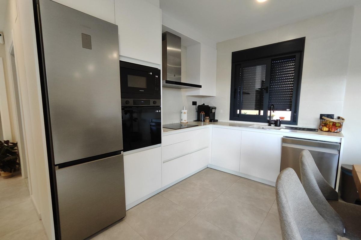 Modern kitchen in the Pinoso villa featuring stainless steel appliances and a clean design for cooking.