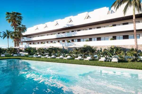 Buitenzicht op een modern appartementencomplex in Finestrat met palmbomen en een zwembad.