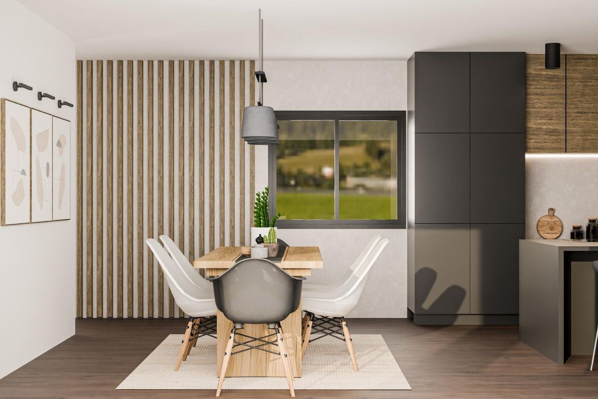 Elegant dining area in a Pinoso villa, featuring a wooden table and stylish chairs under soft lighting.