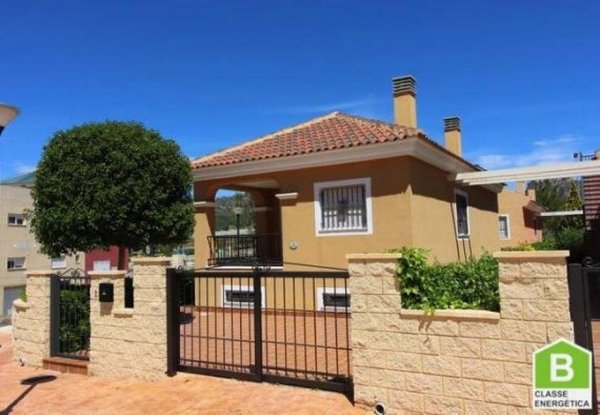 Exterior view of a charming 2-bed villa in La Romana, Costa Blanca South, featuring a gated entrance.