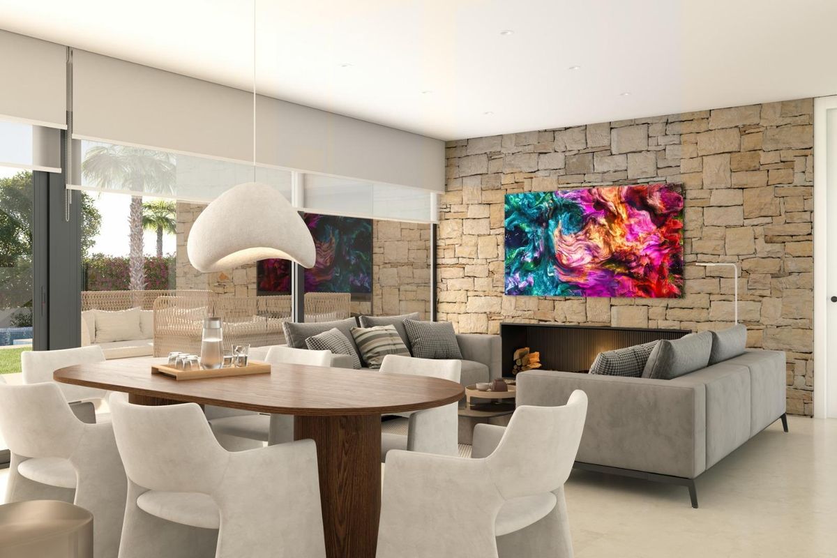 Ruimtelijke woonkamer met een stenen muur en levendige kunstwerken in een 3-slaapkamer villa in Cuevas Del Almanzora.
