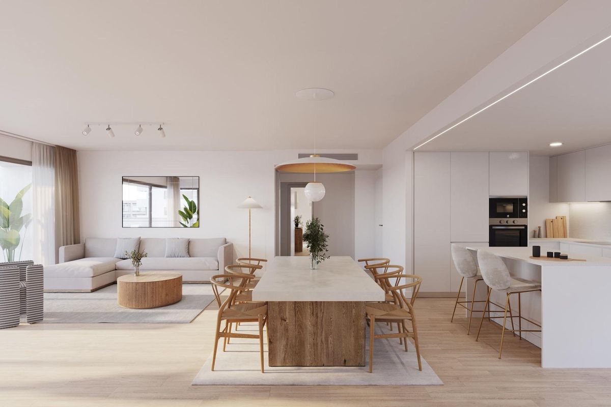 Open dining area in a stylish kitchen, with natural light illuminating the wooden dining table in Alicante apartment.