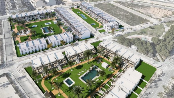 Aerial view of a modern town house community with pools and green spaces in Pilar de La Horadada, Costa Blanca.