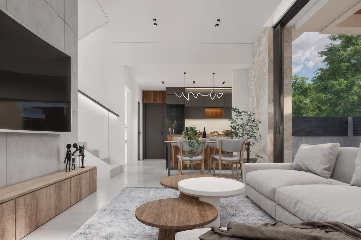 Gezellige woonkamer met modern interieur en zichtbare keuken in een villa in Los Montesinos, Costa Blanca.