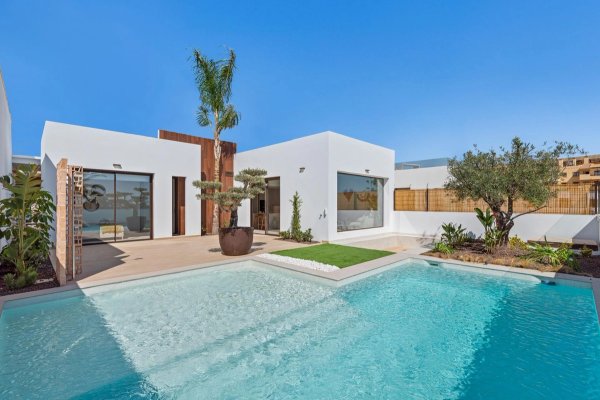 Exterior view of a modern 3-bed villa in Los Alcazares with a pool and landscaped garden.