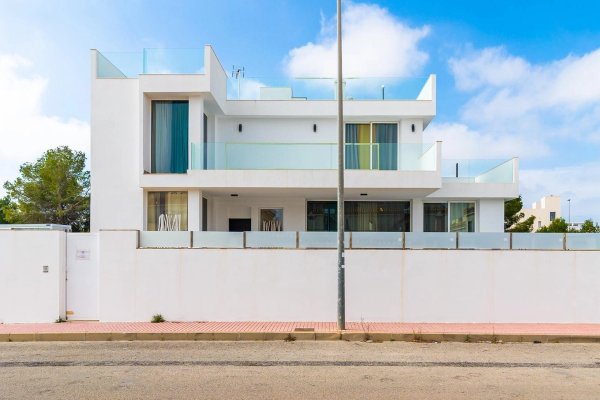 Modern three-bedroom villa in Orihuela Costa, showcasing a bright exterior with balconies and large windows.