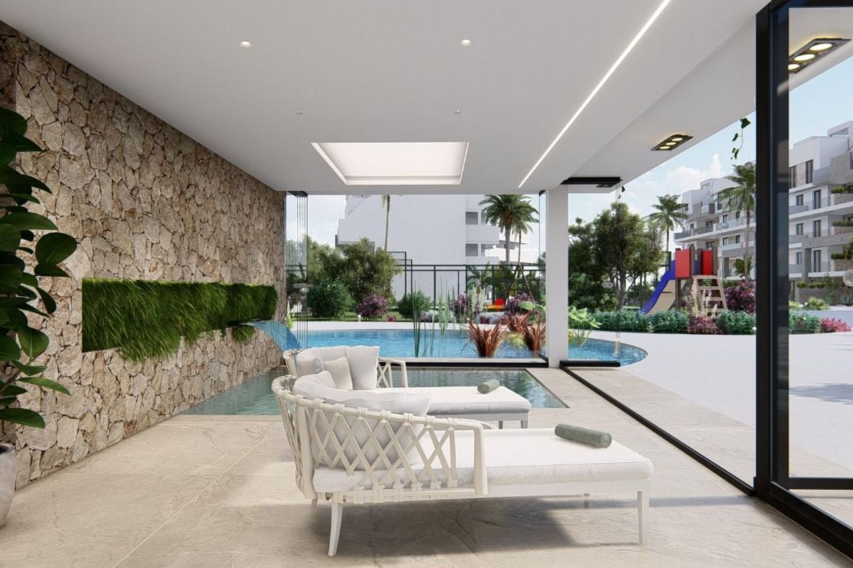 Cozy lounge area with ample light, overlooking the outdoor pool and garden in the apartment's interior.