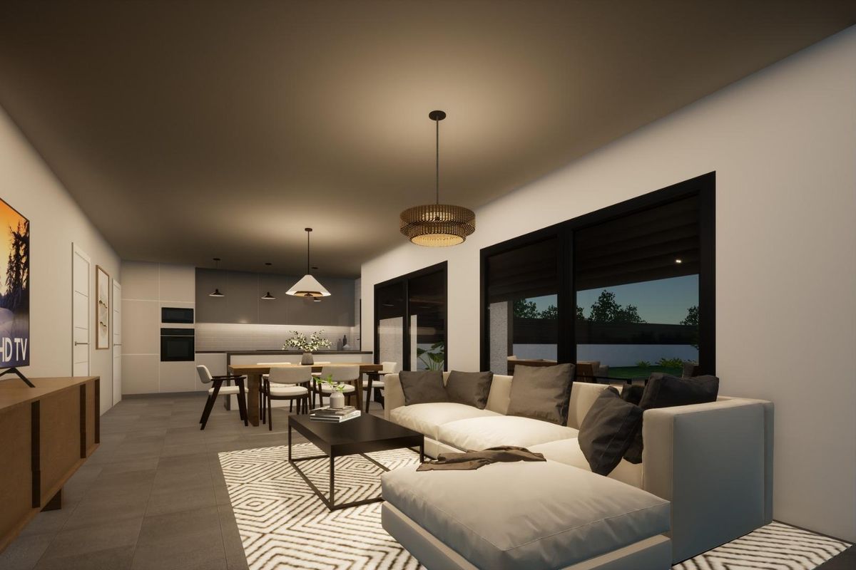 Cozy living room in the Pinoso villa, featuring a TV cabinet and well-lit windows, perfect for relaxation.