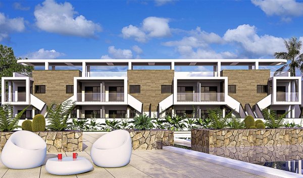 Exterior view of 2-bed bungalows in Pilar de La Horadada, Costa Blanca. Terrace with seating and stone detailing.