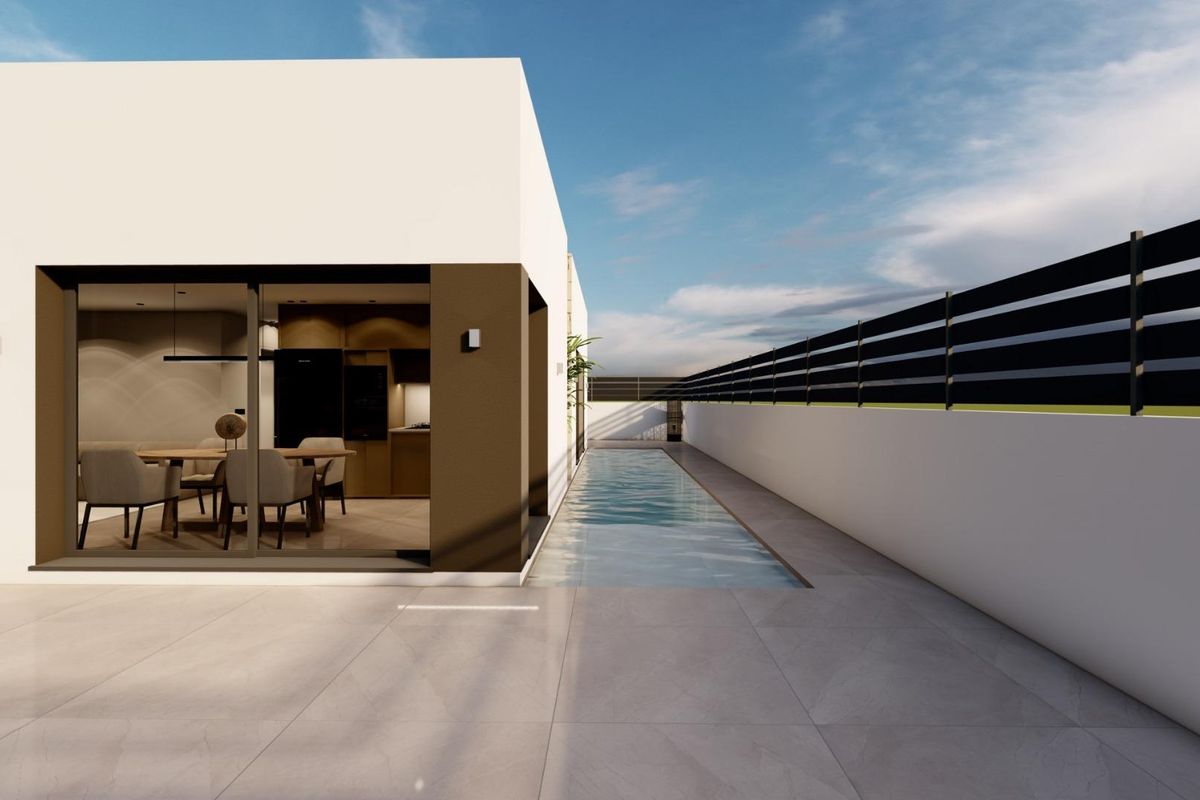 Uitzicht vanuit de tuin van een chique villa in Benijofar, met een strak zwembad en eetruimte.