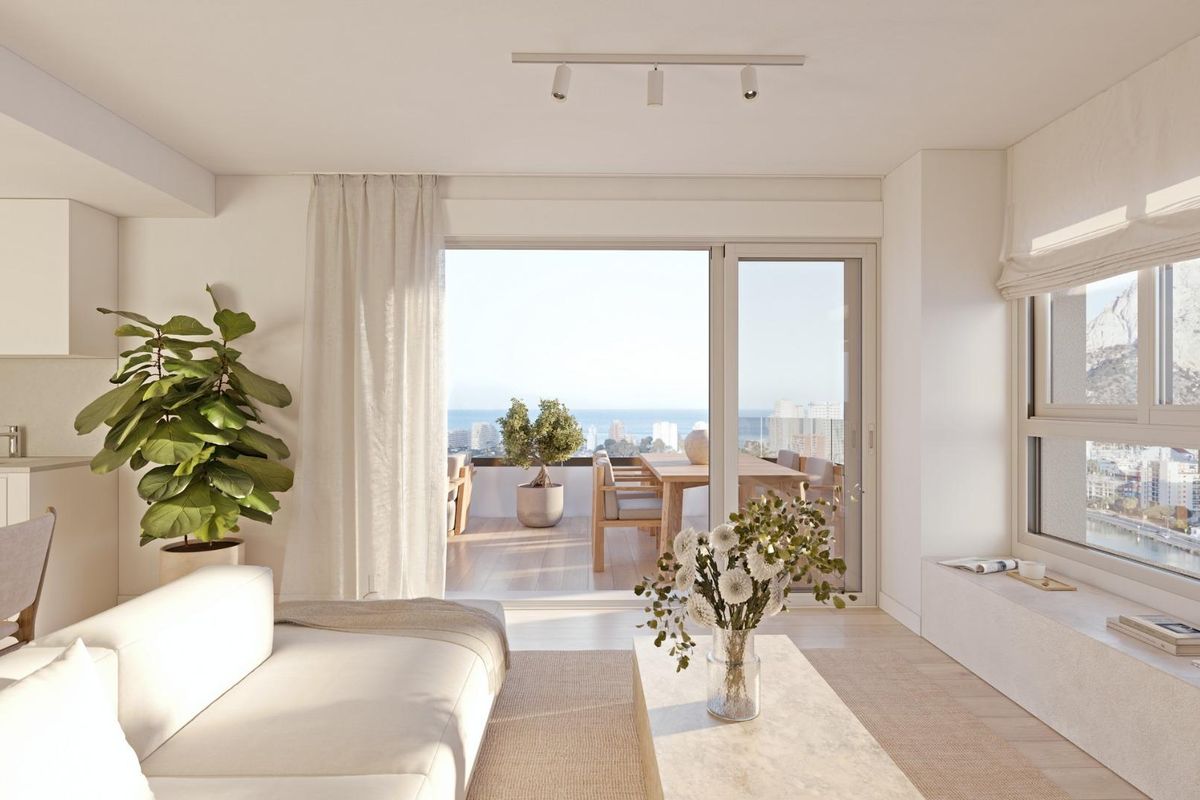 Inviting living space with natural light and ocean views, seamlessly connecting to the terrace in Calpe, Spain.