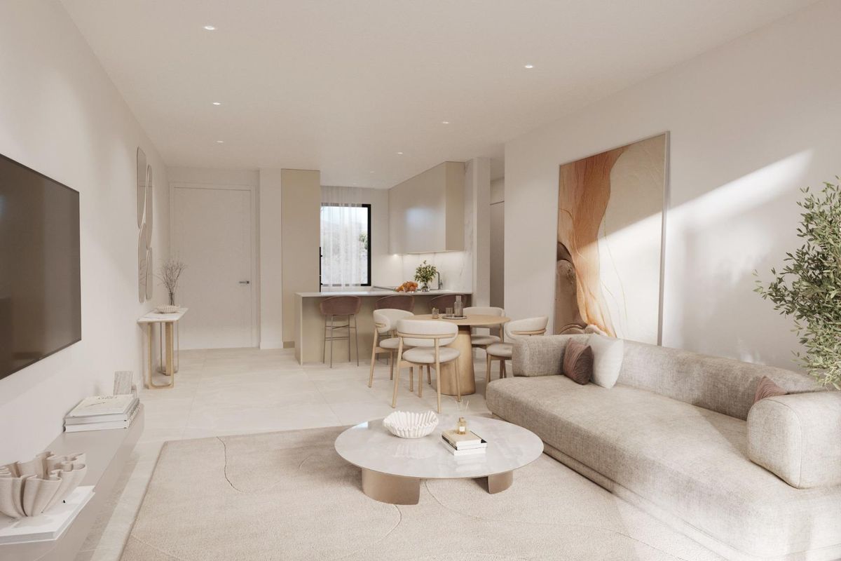 Stijlvol woongedeelte van een 3-slaapkamer appartement in Estepona, met moderne decor en keukenuitzichten.