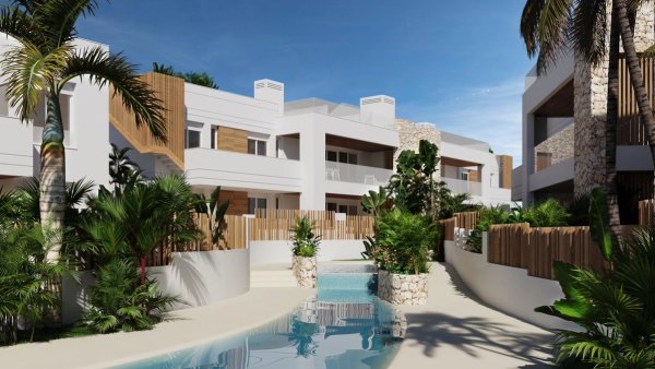 Buitenzicht op een modern bungalowcomplex in San Juan de los Terreros, omringd door weelderig groen.
