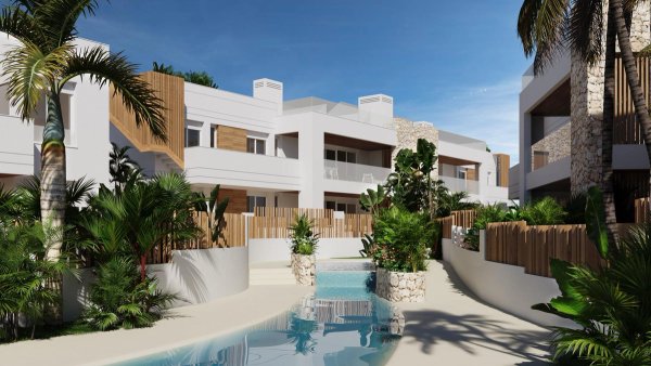 Buitenzicht op een modern bungalowcomplex in San Juan de los Terreros, omringd door weelderig groen.