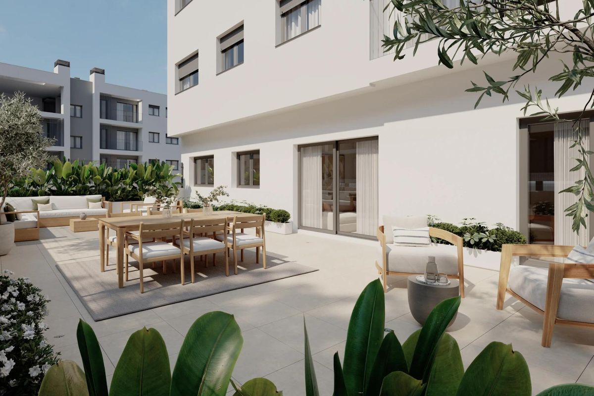 Privéterras van het appartement in Alicante met buitenzitplaatsen en uitzicht op de tuin.
