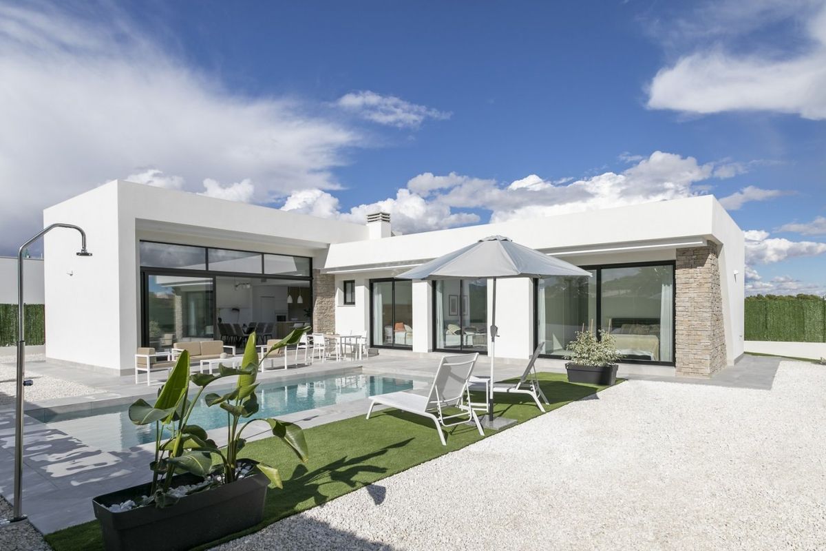 Moderne villa in Calasparra met een stijlvolle poolarea, ligstoelen en een weelderige tuin.