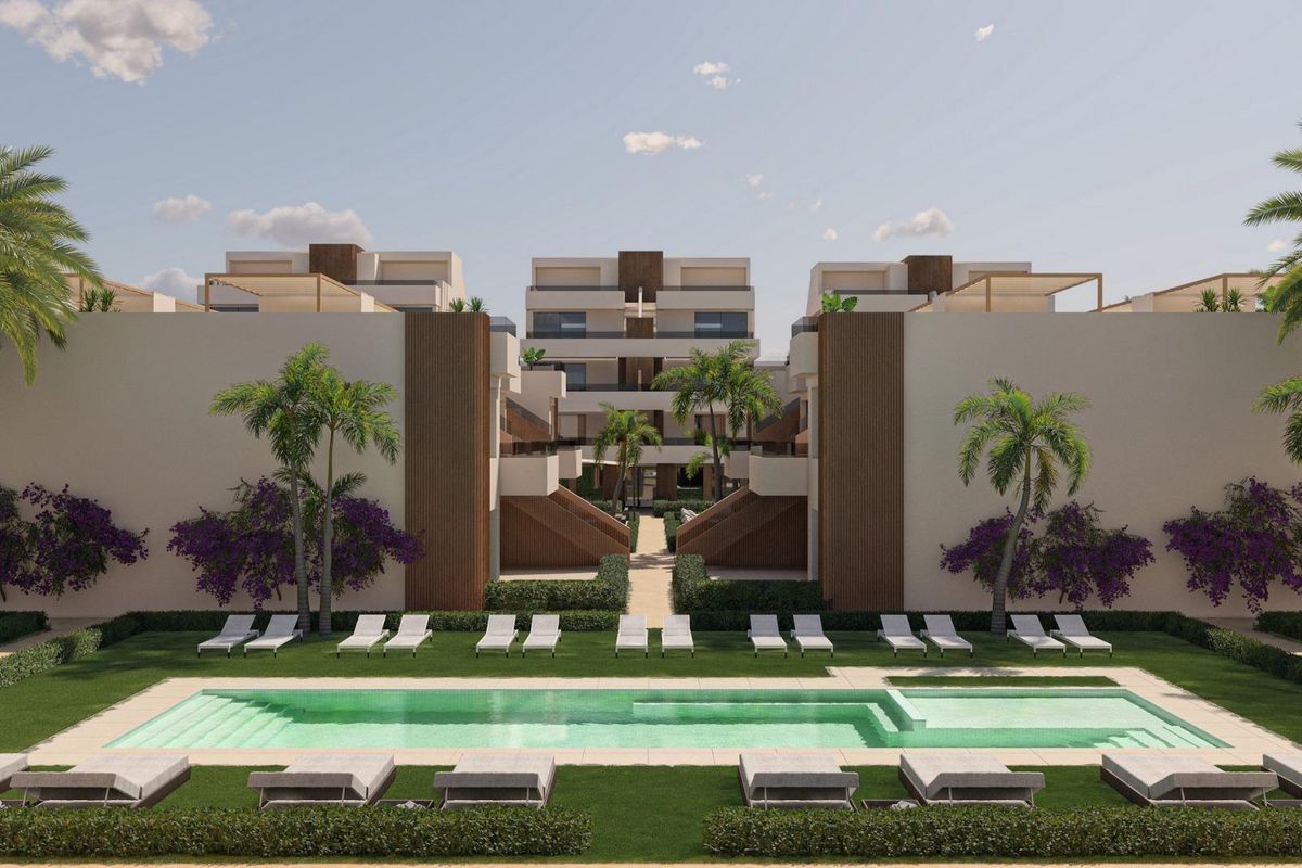Another view of the stunning pool area in Alhama De Murcia, surrounded by loungers and colorful plants.