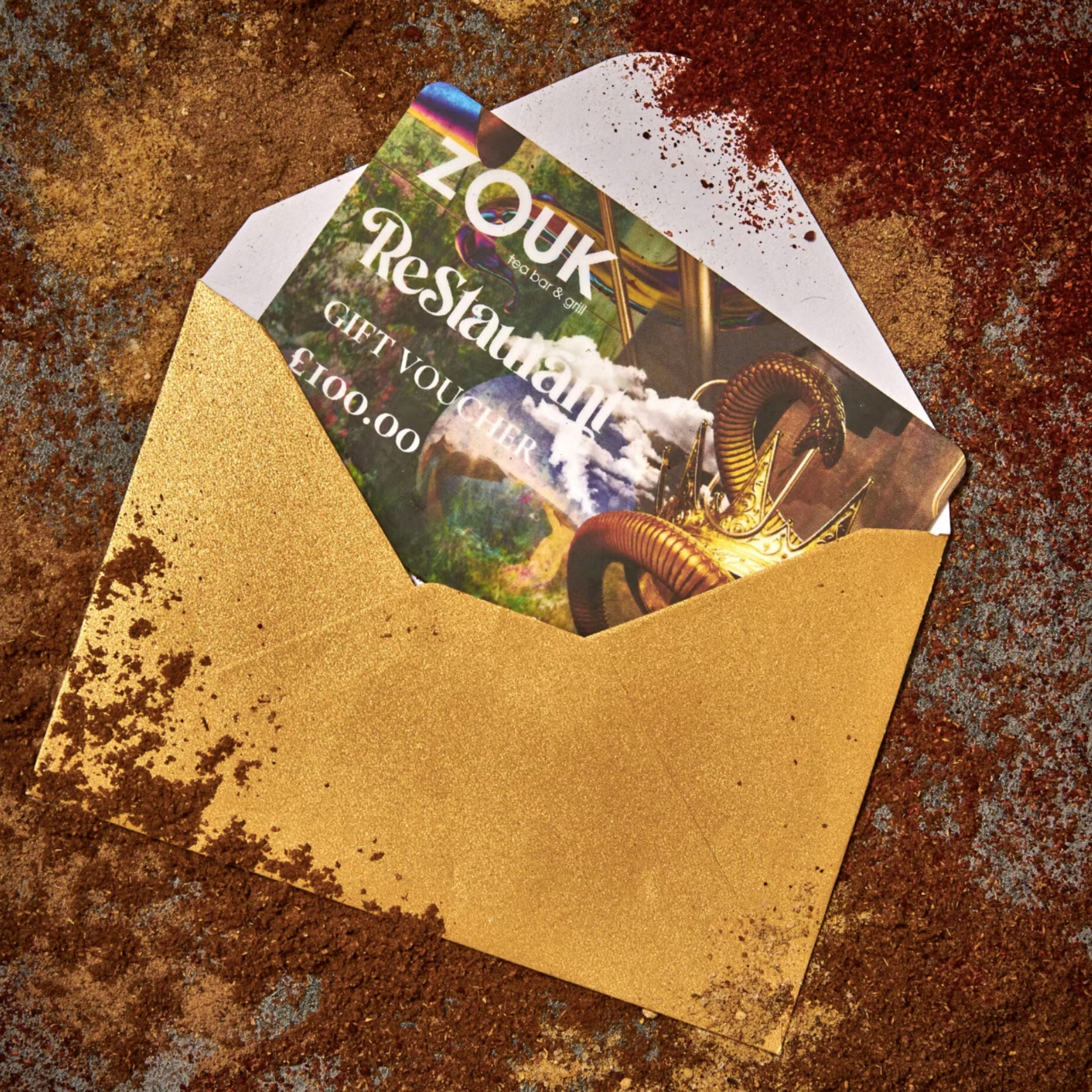 Zouk Restaurant gift voucher design presented in a gold envelope dusted with spices