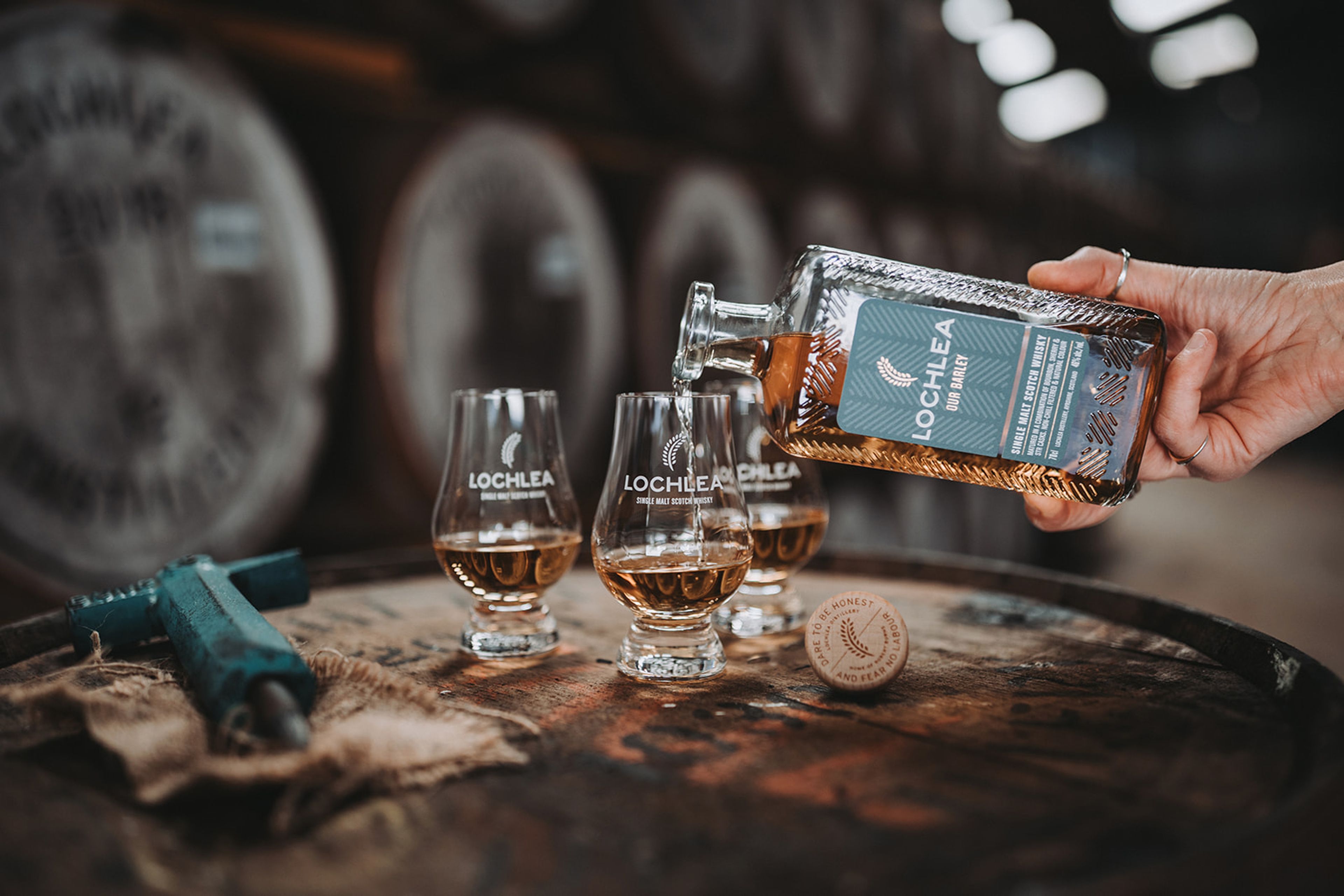 Lochlea single malt whisky poured into tasting glasses on a cask in the distillery warehouse