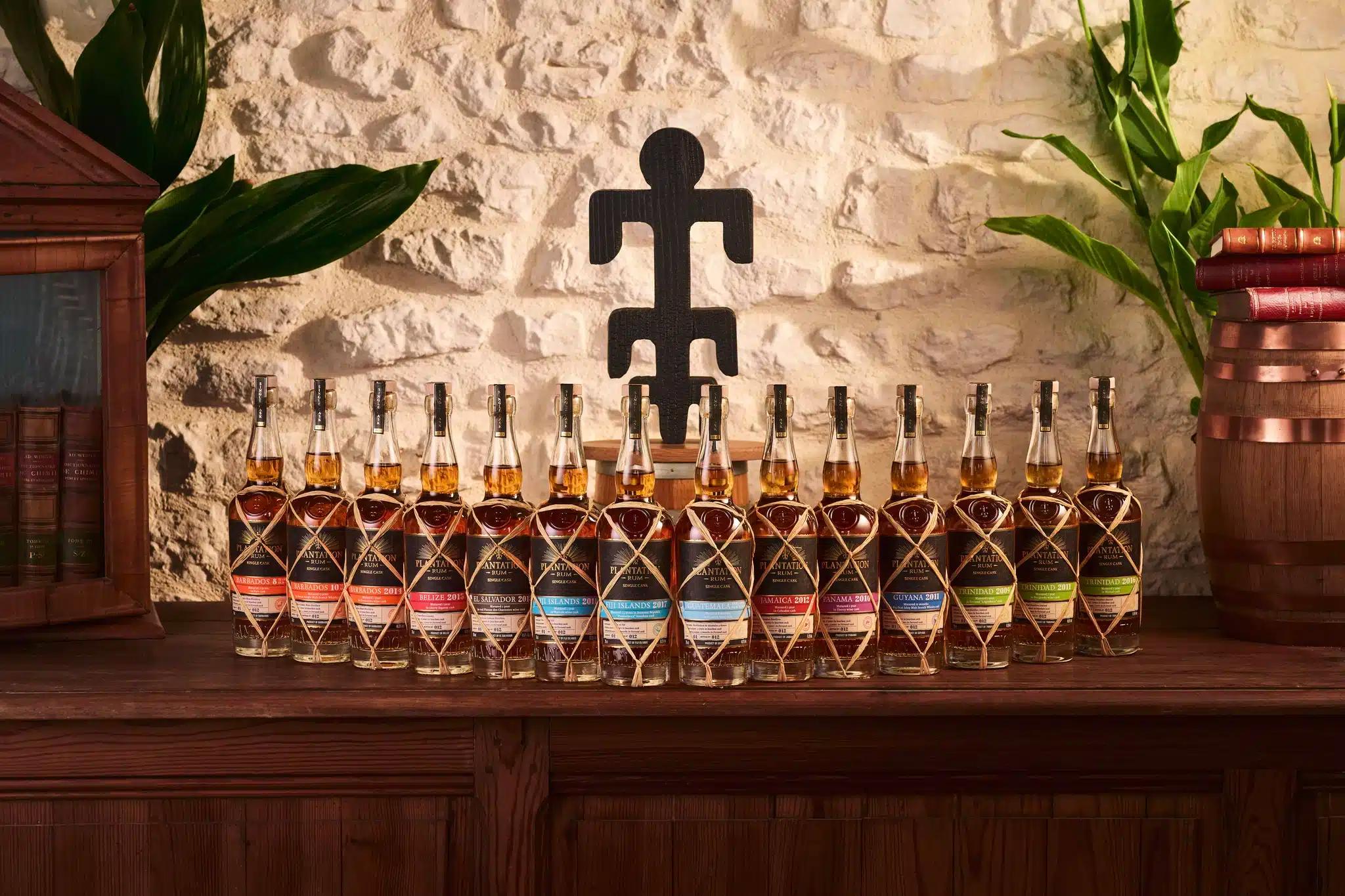 Planteray rums lined up on the tasting table with a guest pouring