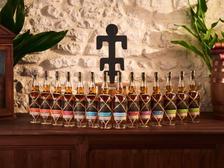 Planteray rums lined up on the tasting table with a guest pouring