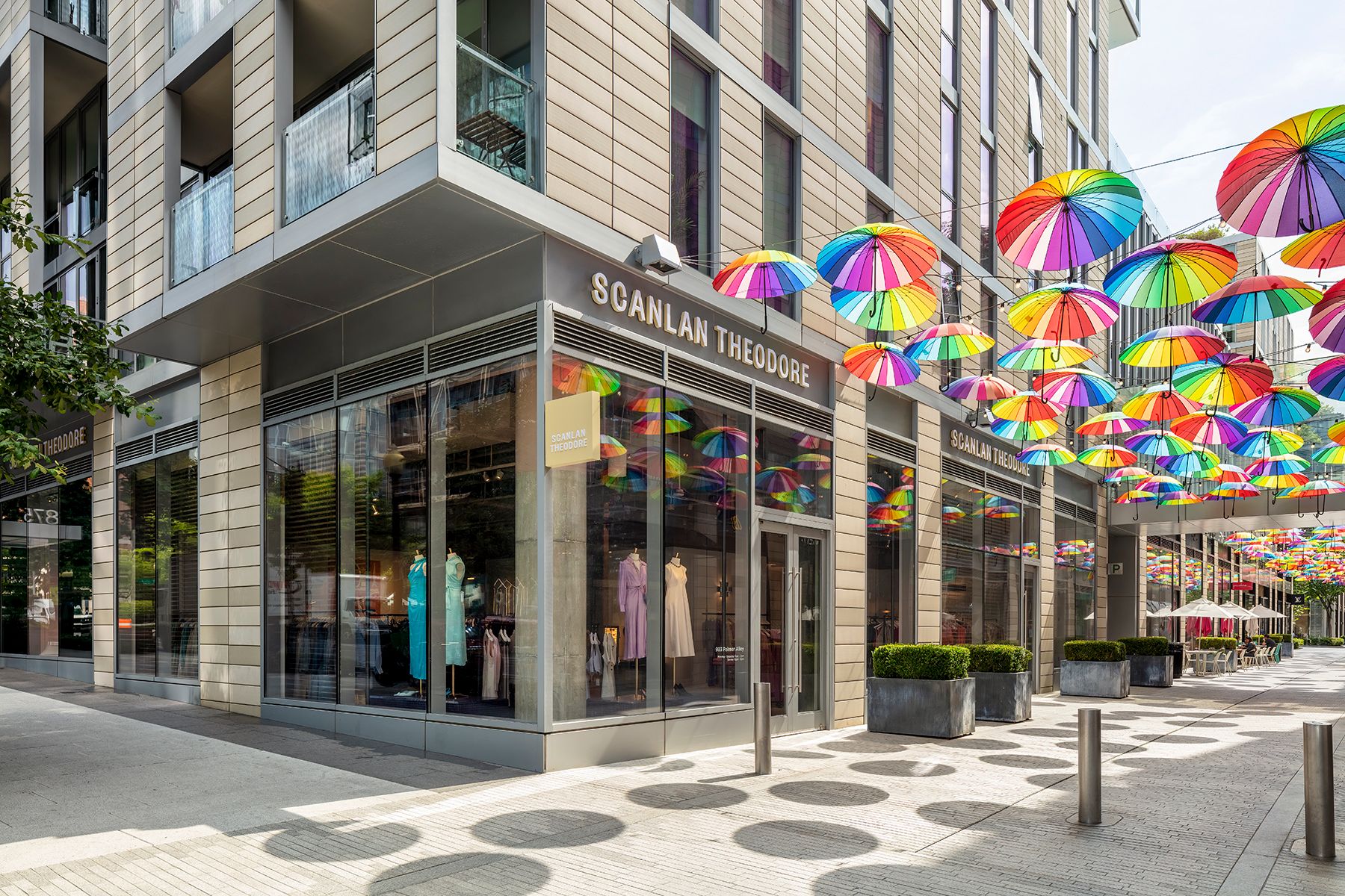 Storefront of the Scanlan Theodore Washington D.C. store with laneway decorations of rainbow-coloured rainbows