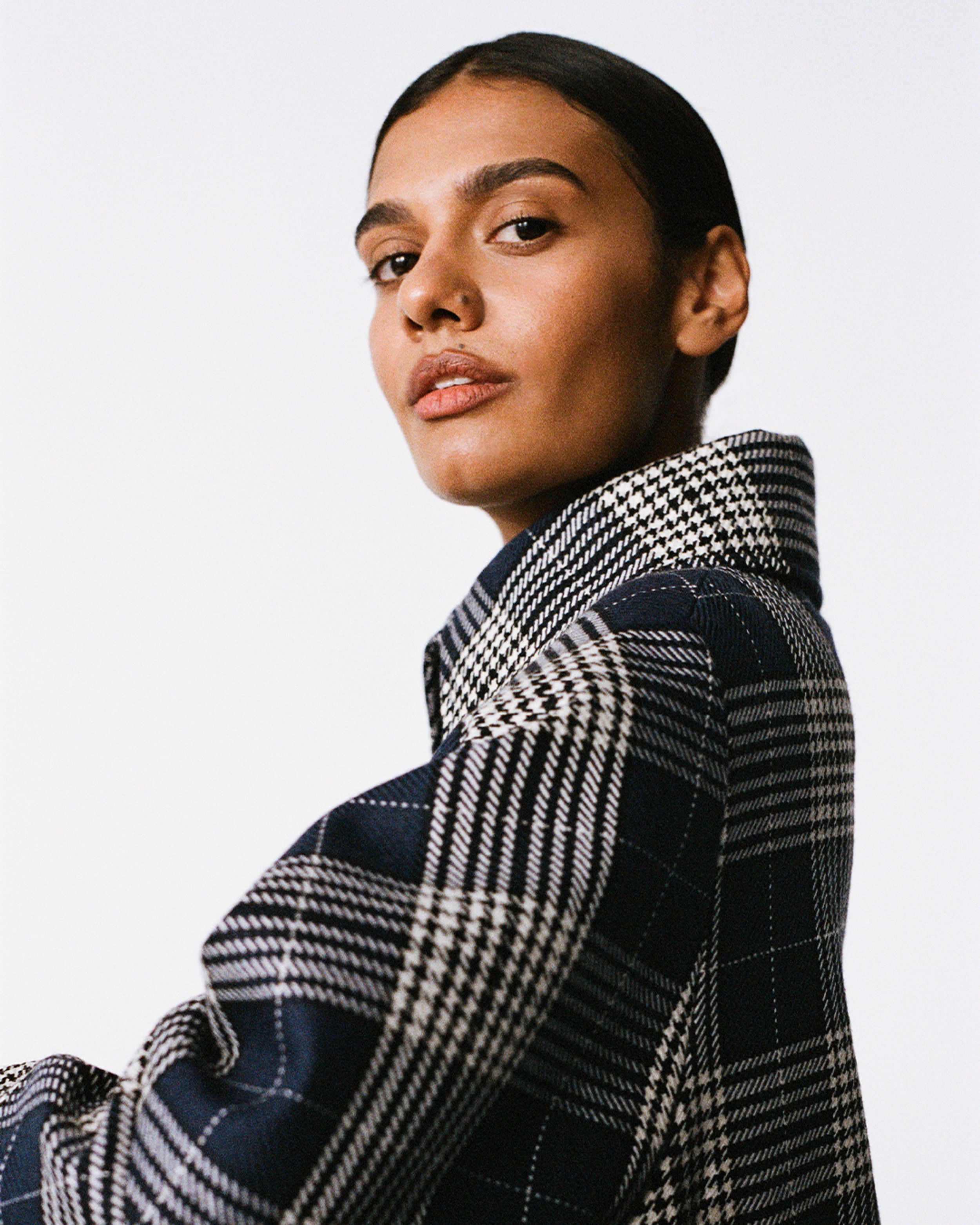 Madeleine Madden wearing dark blue and white plaid jacket