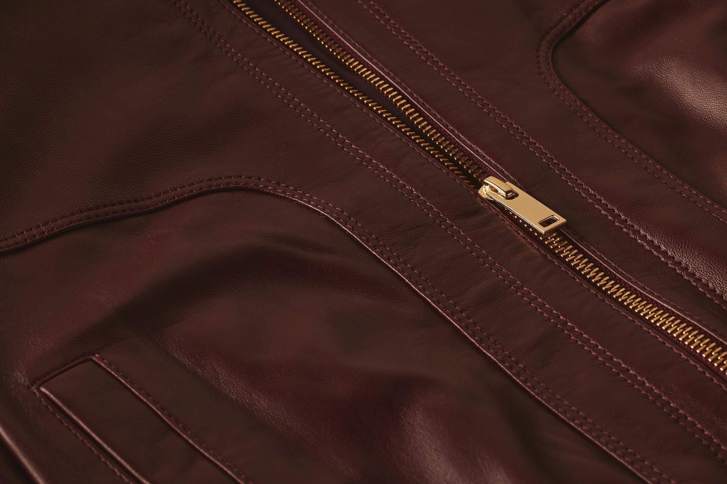 Scanlan Theodore leather bomber jacket with close detailed view of stitch detail and zipper.