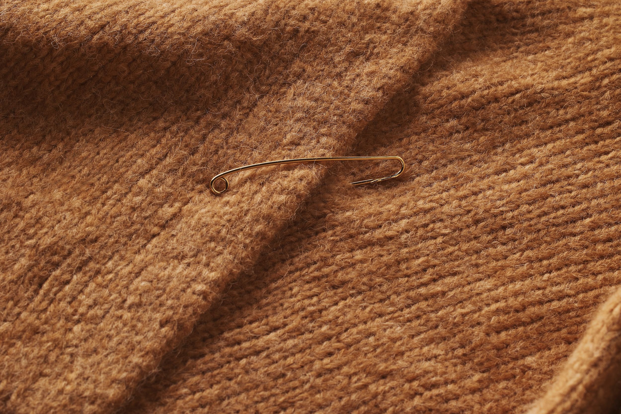 Scanlan Theodore alpaca wrap sweater with close up of texture and gold pin.