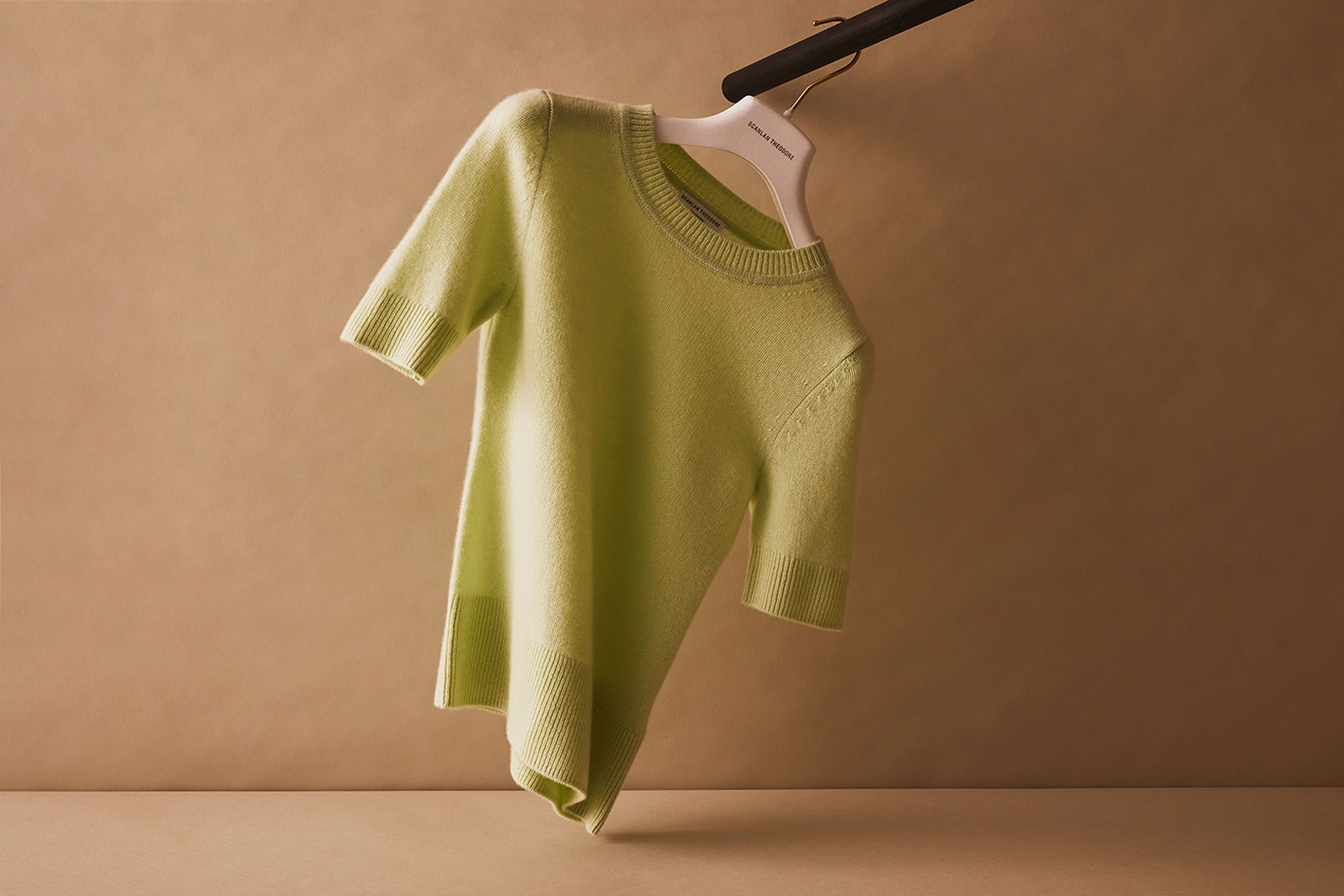 Scanlan Theodore cashmere top with short sleeves hanging on a rail.