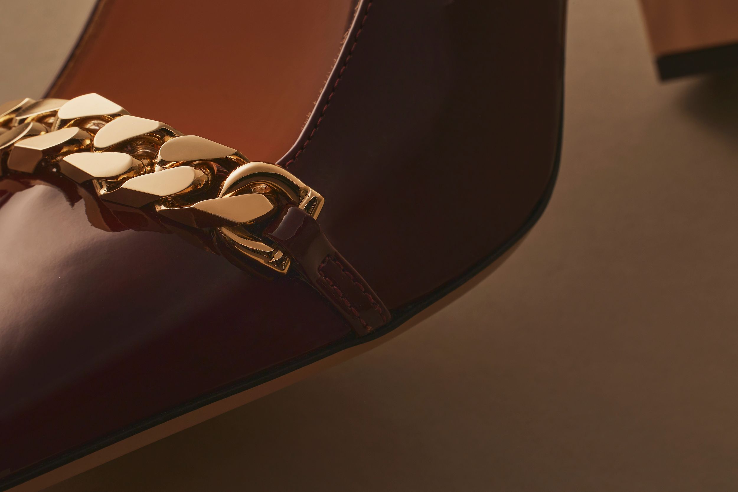 Scanlan Theodore square toe pump with gold chain detail.