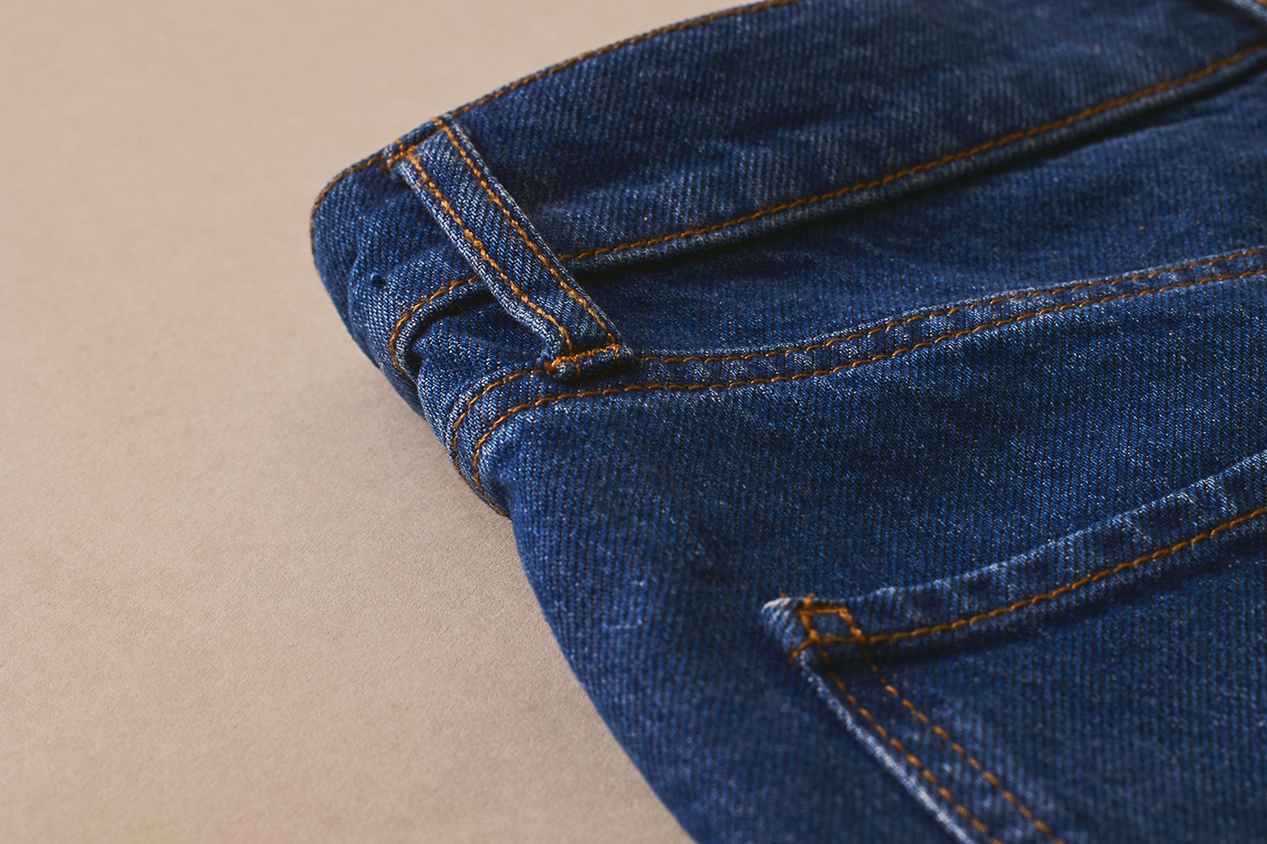 Scanlan Theodore denim jeans in a deep indigo hue and detail of back pocket and belt loop.