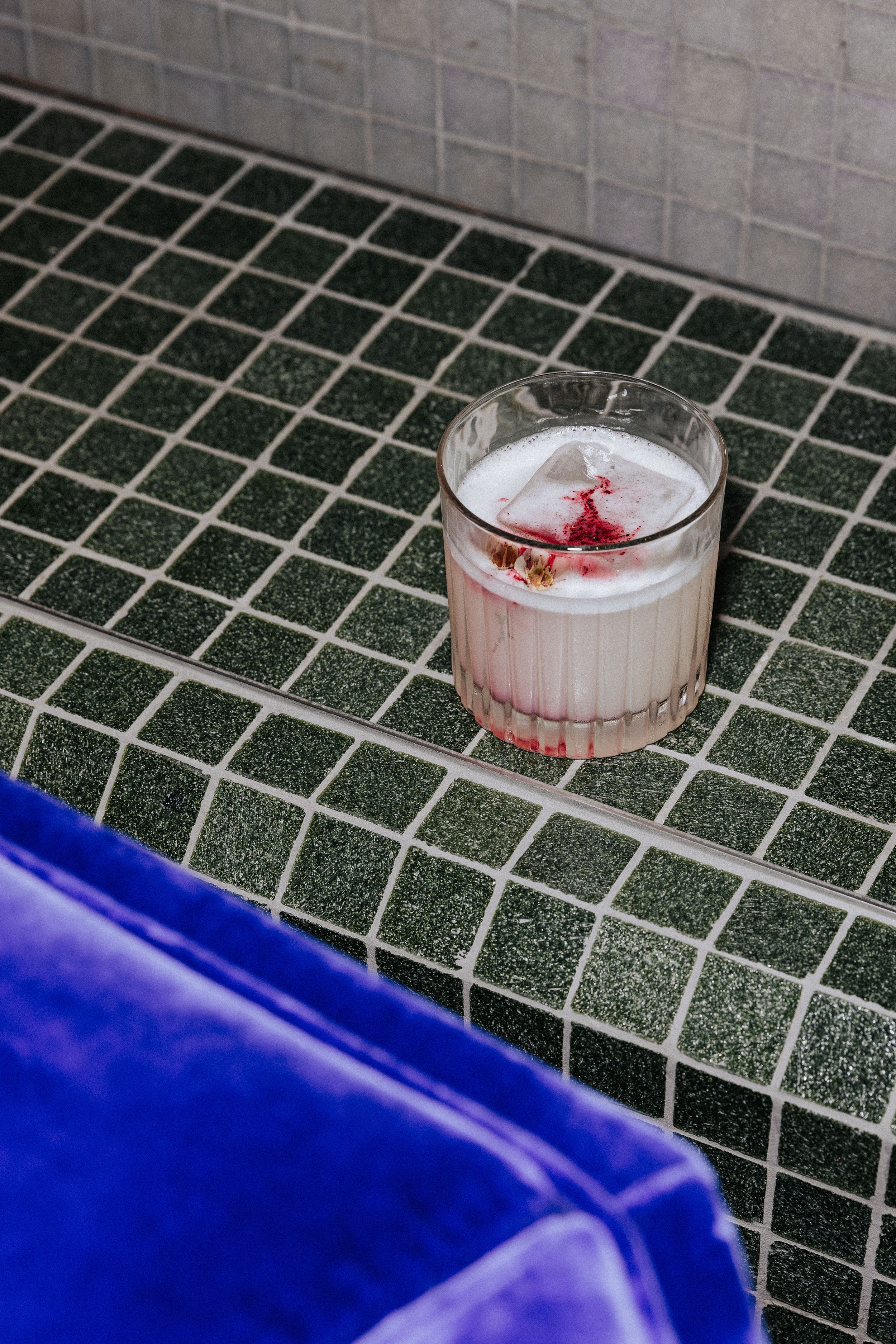 Cocktail served at the event on green tiled bench and blue velvet chair