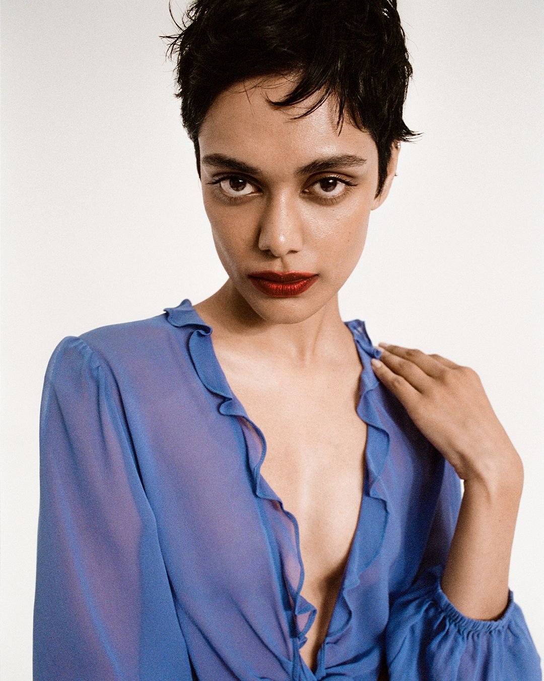 Close up of Zinnia Kumar in a blue silk dress with ruffled collar