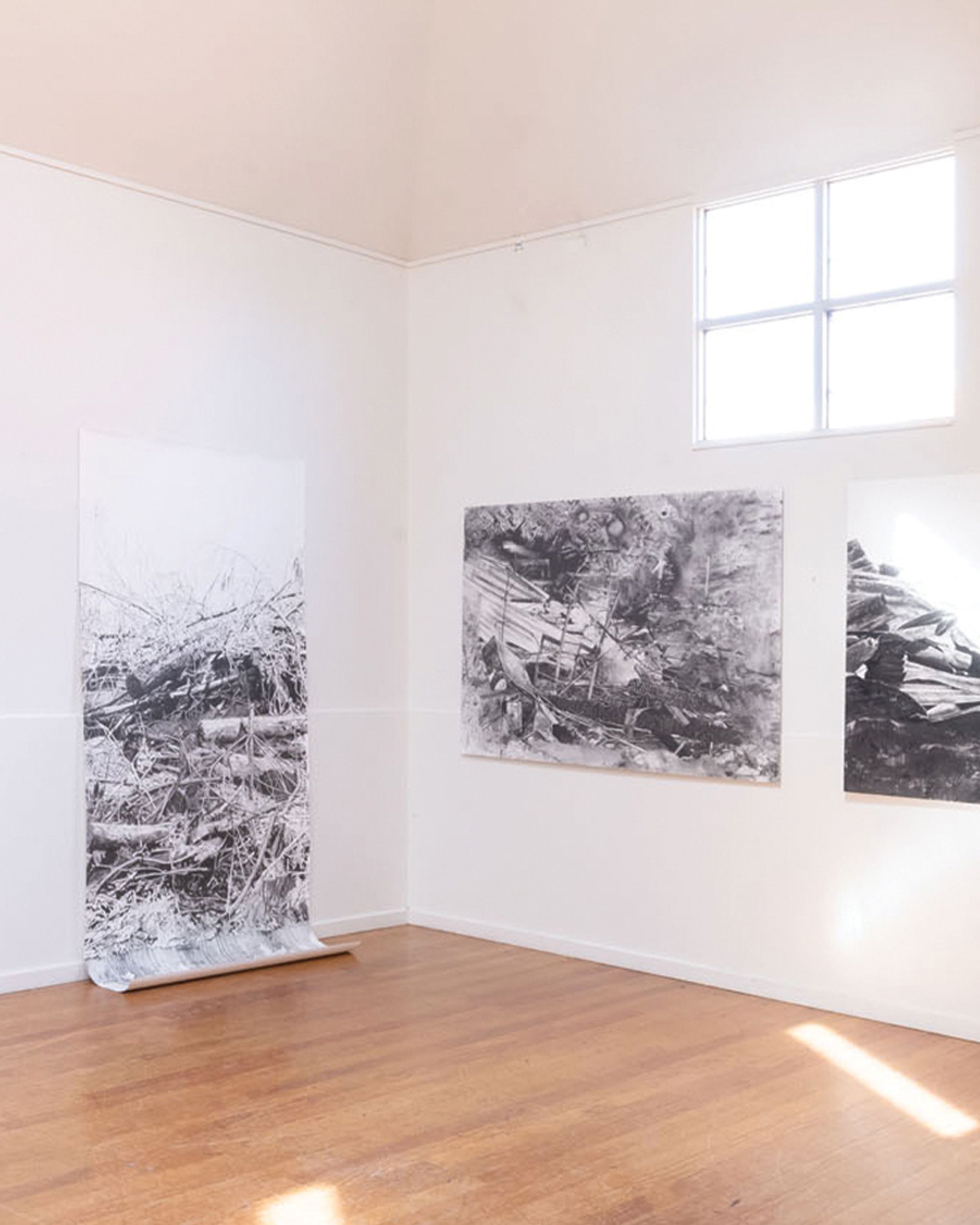 Gallery room of large black and white photographs of wreckages