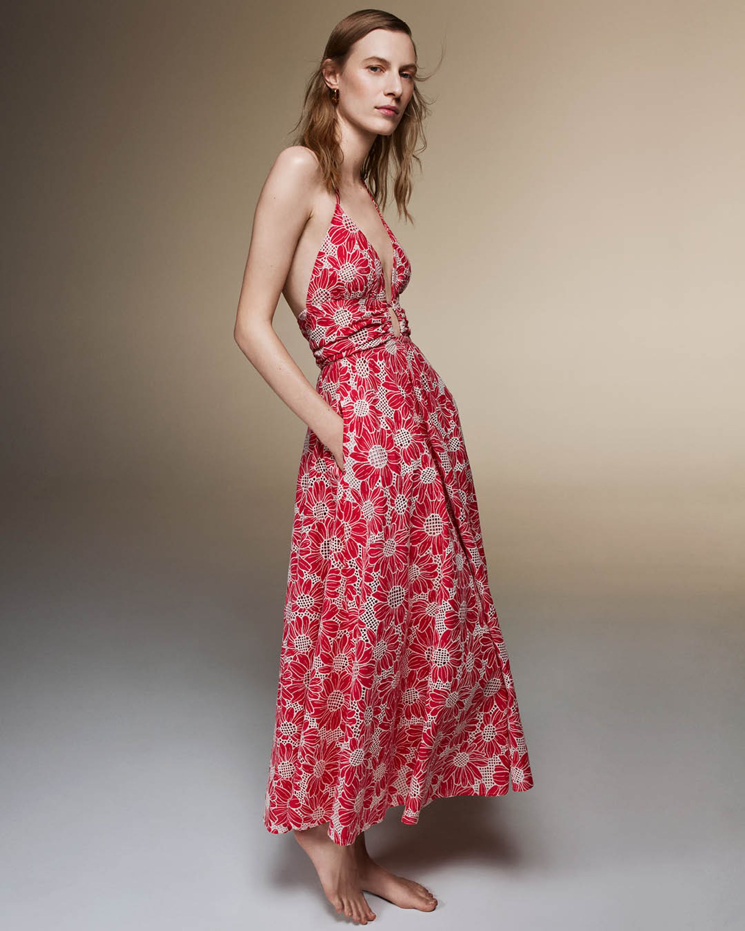 Julia Nobis standing wearing a pink floral embroidered long dress