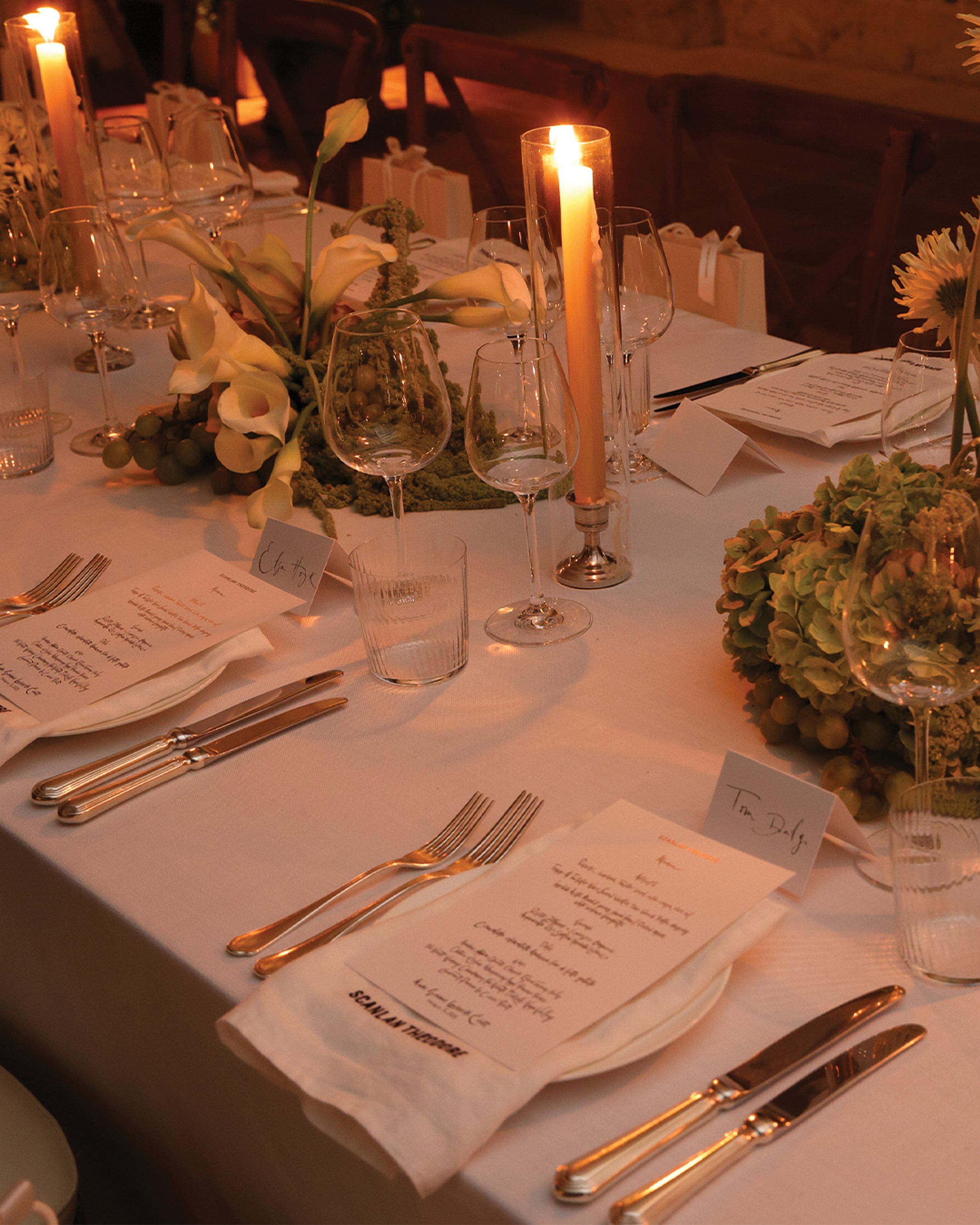 Table setting with various floral arrangements and candles
