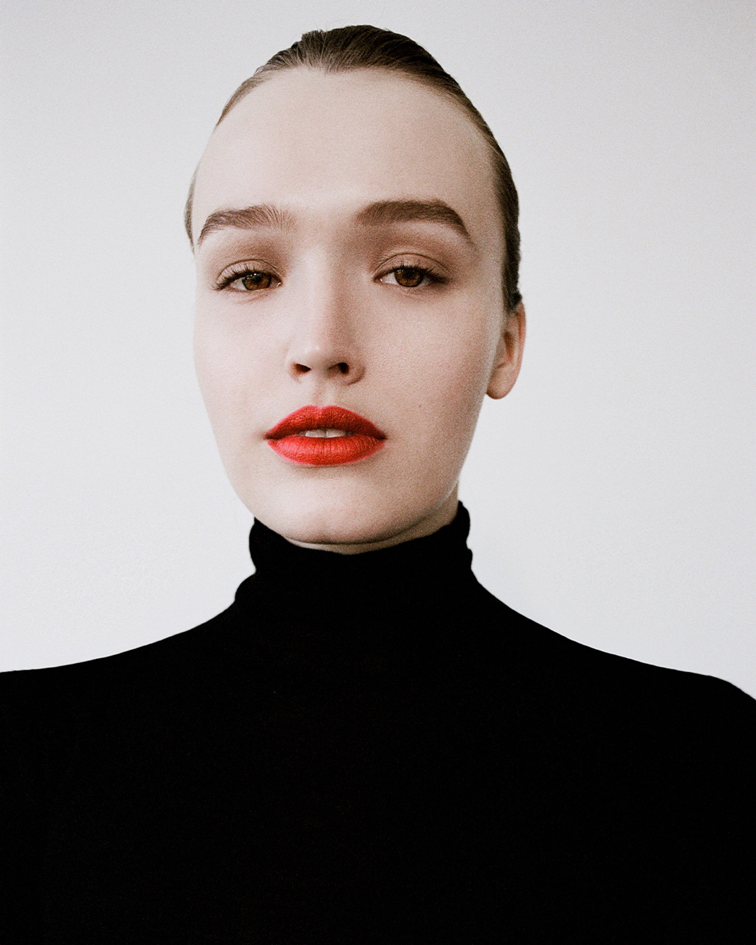 Close up of Maddison Brown in Black Babywool Polo Top and bright red lipstick